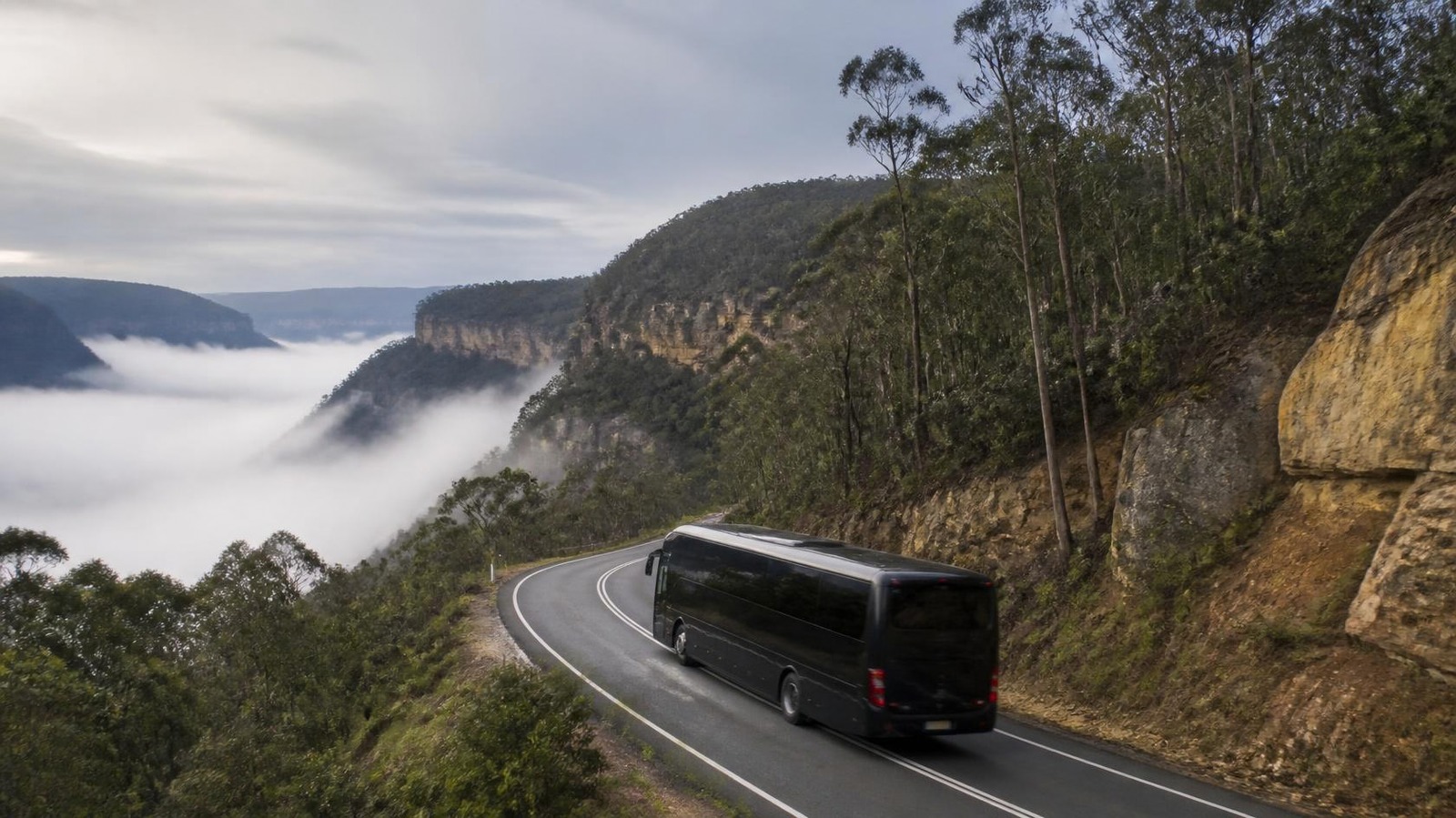 Black coach travelling through the Blue Mountains to Bathurst