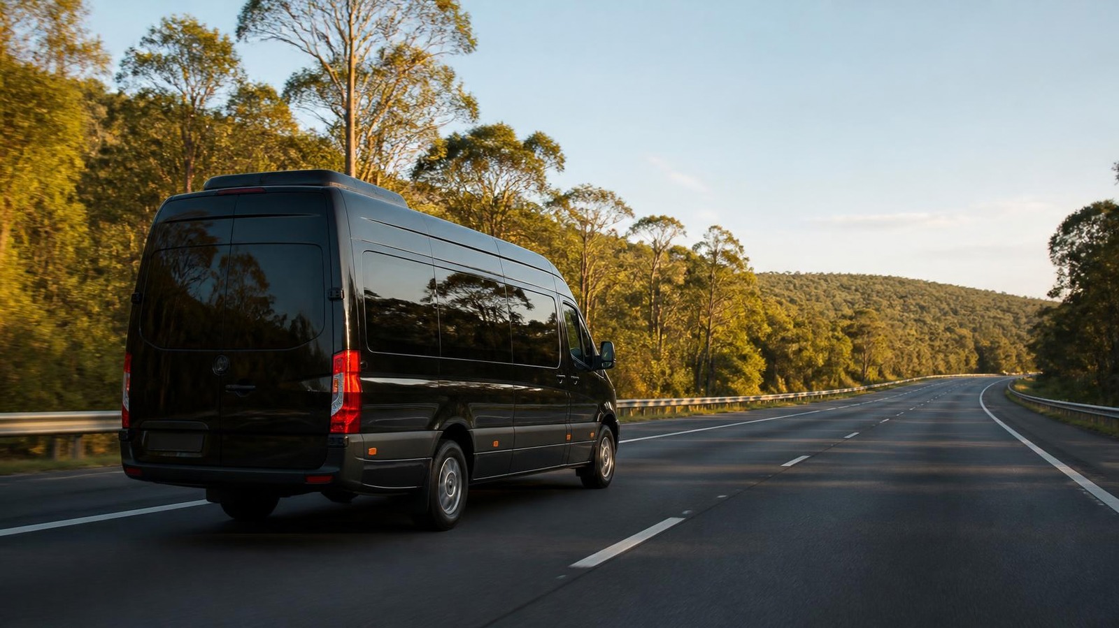 Black minibus travelling from Newcastle to Sydney on the M1 motorway